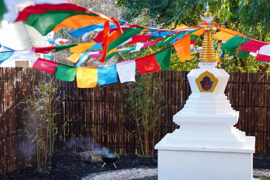a Sangha Unifying Stupa with prayer flags