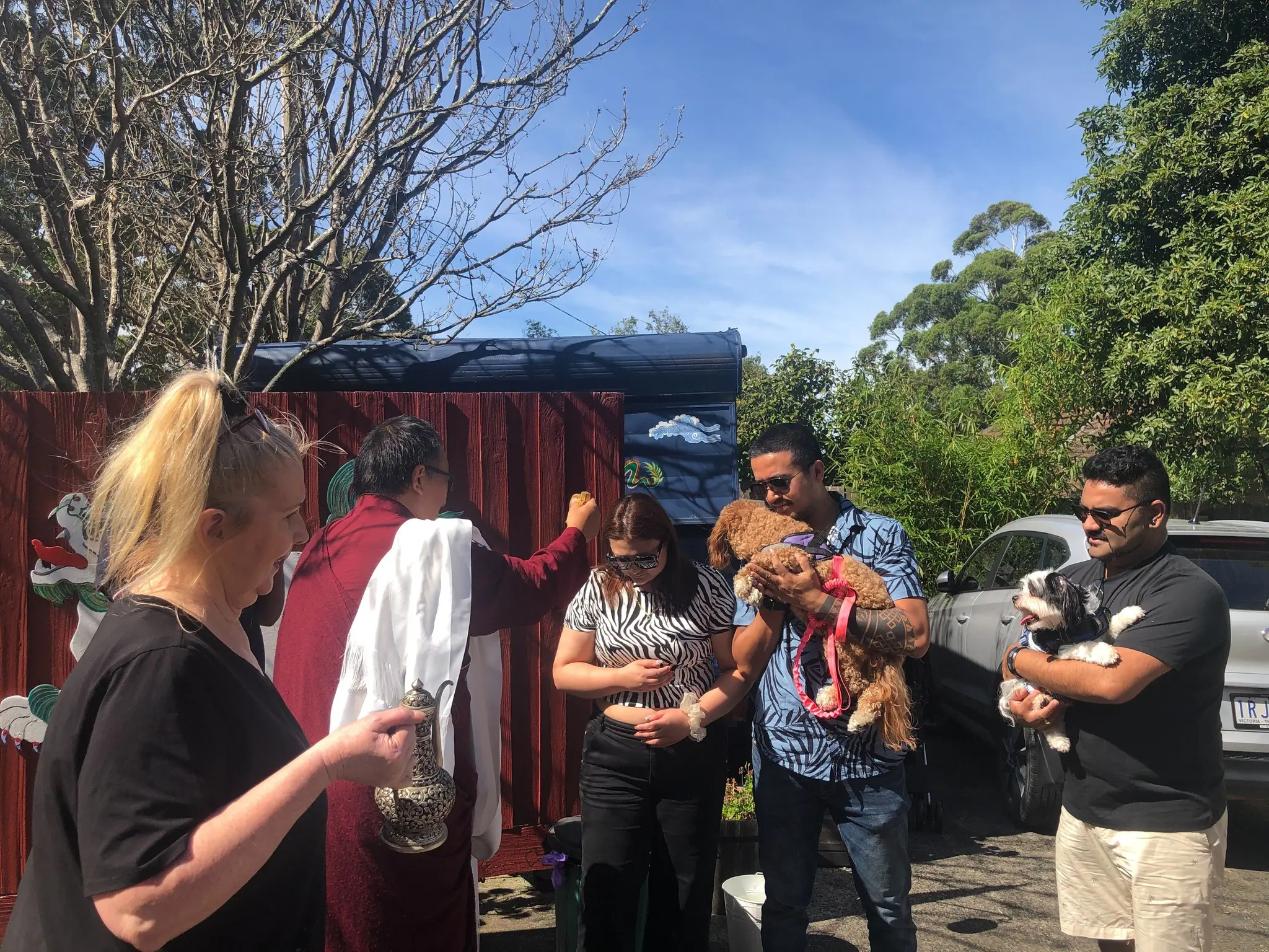 Tibetan Buddhist lama Khentrul Rinpoche blessing people and their dogs